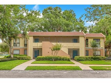 Inviting two-story condo with mature trees, manicured lawn, and visible parking at 419 Sheoah Blvd # 27, Winter Springs, FL 32708