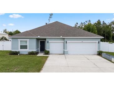 Charming single-story home with a two-car garage and well-maintained lawn at 4811 Sw 108Th Place Rd, Ocala, FL 34476