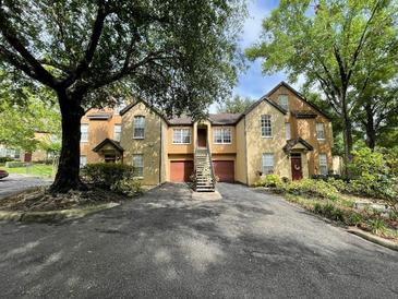 Beautiful townhome complex with private parking and mature landscaping providing shade and curb appeal at 6400 Raleigh St # 3015, Orlando, FL 32835