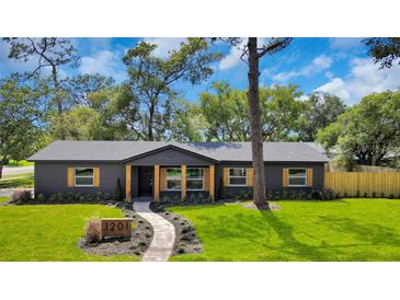 Beautifully renovated home with a landscaped front yard and inviting walkway to the front door at 1201 Manchester Rd, Maitland, FL 32751