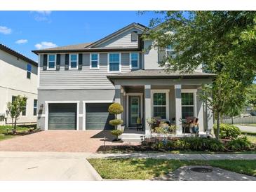 Charming two-story home with a brick driveway and well-manicured landscaping offers excellent curb appeal at 14639 Winter Stay Dr, Winter Garden, FL 34787