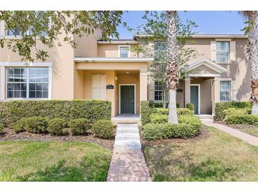 Charming townhome with a well-manicured front yard and inviting entrance at 14706 Driftwater Dr, Winter Garden, FL 34787
