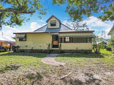 Charming one-story home featuring a welcoming front porch and a brick path leading to the entrance at 1511 New York Ave, St Cloud, FL 34769