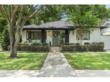 Charming single Gathering home featuring an inviting front porch, lush landscaping and brick pathway at 1701 Canton Street, Orlando, FL 32803