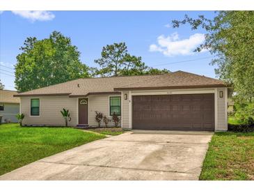 Charming single-story home with a well-maintained lawn and attached two-car garage at 3685 Sunday Dr, Deltona, FL 32738
