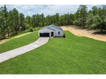 New construction featuring a charming single-story home, driveway, and freshly laid lawn at 6106 Sw 127 Avenue Rd, Ocala, FL 34481