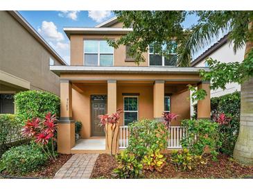 Charming two-story home with a covered front porch and well-maintained landscaping at 9389 Meadow Hunt Way, Winter Garden, FL 34787