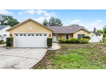 Charming single-story home featuring an attached two-car garage and a well-manicured front lawn at 117 Clowson Ct, Ocoee, FL 34761