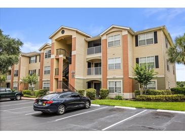 Attractive condo complex featuring a mix of stucco and siding, with well-maintained landscaping at 1979 Summer Club Dr # 115, Oviedo, FL 32765