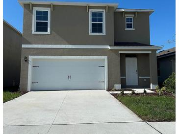 Charming two-story home with a two-car garage and well-maintained lawn at 4912 Kaia Ave, Winter Haven, FL 33884