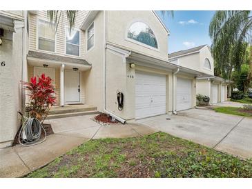 Inviting condo featuring a one-car garage and well-maintained landscaping, creating a welcoming curb appeal at 6057 Lake Pointe Dr # 408, Orlando, FL 32822