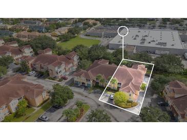 This is an aerial view of a multi-unit dwelling showcasing the building's layout and surrounding neighborhood at 12220 Wild Iris Way # 103, Orlando, FL 32837
