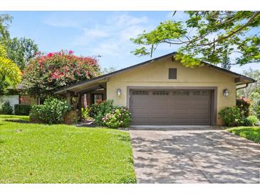 Charming single story home featuring an attached two car garage and a well manicured front lawn at 1247 Rosemary Dr, Orlando, FL 32807