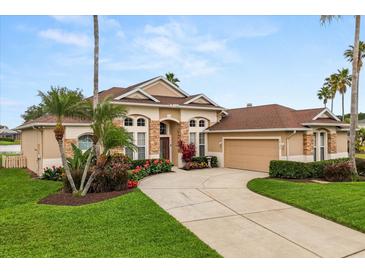 Charming single-Gathering home featuring a two-car garage, and a well-manicured lawn and garden at 14174 Islamorada Dr, Orlando, FL 32837