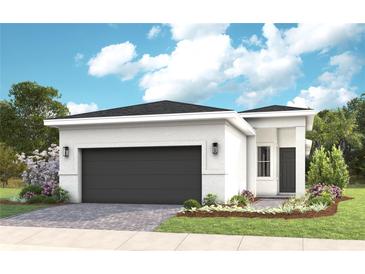 Charming single-story home with a modern design, landscaped yard, and a two-car garage at 1461 Santorini Way, Tavares, FL 32778