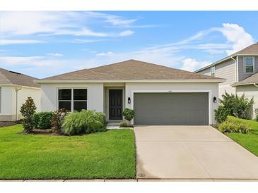 Charming single-story home with a well-maintained lawn, and a two car garage at 1773 Groveline Rd, St Cloud, FL 34771