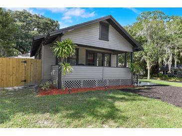 Charming home with a cozy front porch, landscaped yard, and classic architectural details at 205 W Princeton St, Orlando, FL 32804
