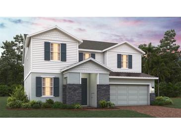 Charming two-story home boasts a blend of stone and siding accents, complemented by a two-car garage and meticulously landscaped lawn at 2095 Heart Lake Dr, Groveland, FL 34736