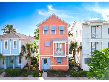 Charming two-story home with a light orange facade, blue shutters, and a cozy balcony at 3062 Pirate Way, Kissimmee, FL 34747