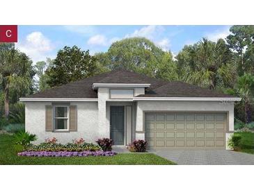 Charming one-story home featuring a two-car garage, neutral paint, and lush landscaping at 2026 Firethorn Loop, Haines City, FL 33844