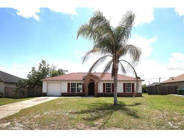 Charming single-story home with well-maintained lawn and a mature palm tree in a sunny neighborhood at 2041 Swanson Dr, Deltona, FL 32738