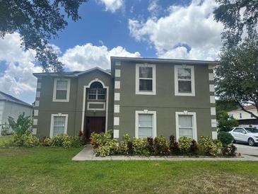 Charming two-story home features a well-manicured lawn and lush landscaping at 2818 Sheila Dr, Apopka, FL 32712