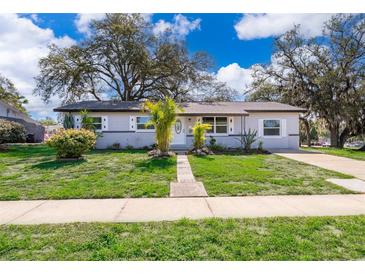 Charming single-story home featuring a landscaped front yard and a welcoming entrance at 3403 Canute Pl, Orlando, FL 32818