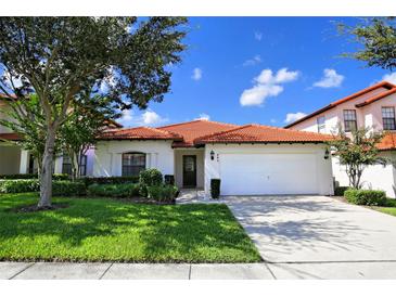 Charming single-story home featuring a well-maintained lawn and a tile roof at 446 Summer Place Loop, Clermont, FL 34714