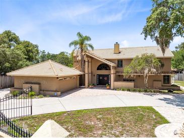 Stunning two-story home featuring a grand entrance and a matching detached two-car garage at 4674 Hall Rd, Orlando, FL 32817