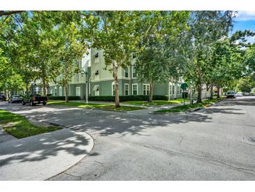 Beautiful green exterior of this multi-story home with manicured landscaping at 501 Water St # 501, Celebration, FL 34747