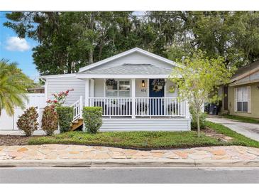 Charming home with a welcoming front porch, manicured landscaping, and classic curb appeal at 674 Douglas Ave, Winter Park, FL 32789