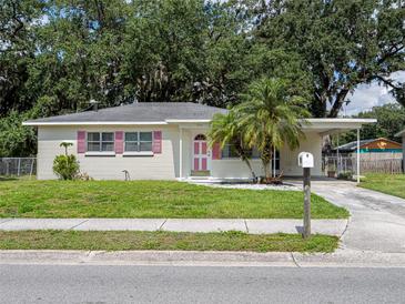 Charming single-story home with a well-maintained lawn and a palm tree in the front yard at 1244 Woodland Ave, Lakeland, FL 33801