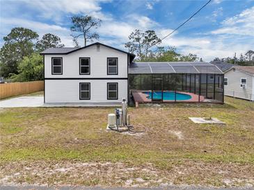 Two-story home with a screened-in pool enclosure and spacious yard at 1840 Lillian Dr, St Cloud, FL 34771