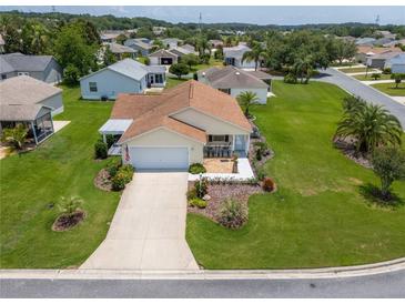 Charming single-story home in a well-maintained community, featuring a manicured lawn and inviting curb appeal at 2167 Kerwood Loop, The Villages, FL 32162