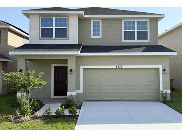 Two-story home with a two-car garage, well-maintained lawn and landscaping, plus stylish neutral exterior paint at 4433 Sagefield Dr, St Cloud, FL 34773