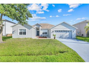Charming single-story home featuring a well-maintained lawn and a two-car garage at 560 Viceroy Ct, Kissimmee, FL 34758
