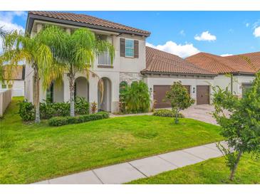 Charming home featuring a well-manicured lawn, a three-car garage, and tropical landscaping at 8491 Pippen Dr, Orlando, FL 32836