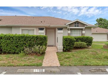 Charming single-story home featuring a well-maintained lawn and tiled walkway at 1156 Lucaya Cir, Orlando, FL 32824