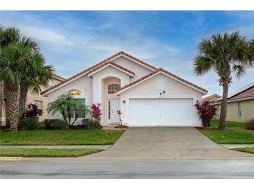 Charming single-Gathering home featuring a red tile roof, well-manicured lawn, and a two-car garage at 117 Rosso Dr, Davenport, FL 33837