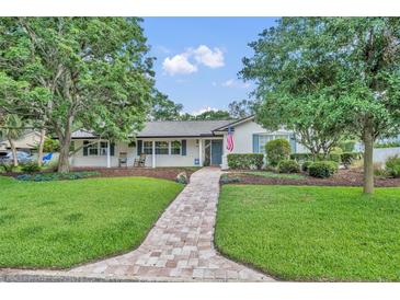 Charming single-story home with lush lawn, brick walkway, and inviting curb appeal at 2450 Mcintosh Way, Maitland, FL 32751