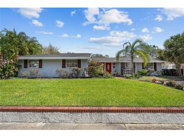 Charming one-story home featuring a well-manicured lawn and a classic brick border at 2801 Plaza Terrace Dr, Orlando, FL 32803