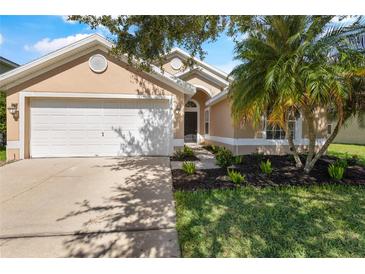 Charming single-story home featuring a two-car garage and lush landscaping at 3078 Mandolin Dr, Kissimmee, FL 34744