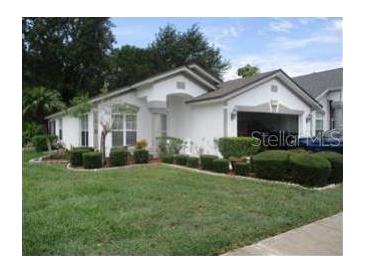 Charming single-story home featuring manicured landscaping and an attached two-car garage at 5760 Arnold Zlotoff Dr, Orlando, FL 32821