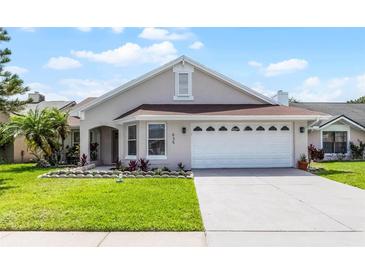 Charming single-story home featuring a well-maintained lawn and a two-car garage, under a sunny sky at 635 Holbrook Cir, Lake Mary, FL 32746