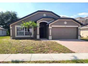 Charming single-story home with a two-car garage and well-maintained landscaping, creating excellent curb appeal at 928 Chanler Dr, Haines City, FL 33844