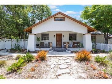 Charming home featuring a welcoming front porch, decorative stone path, and a meticulously landscaped front yard at 1505 Magnolia Ave, Sanford, FL 32771
