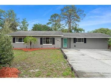 Charming single-story home featuring a well-maintained lawn and a tidy, inviting exterior at 16 Lake Drive, Debary, FL 32713