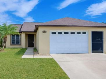 Charming single-story home features a well-maintained lawn, inviting entrance, and a convenient two-car garage at 3260 Pinto Dr, Kissimmee, FL 34746