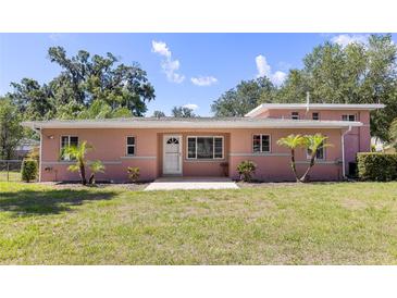Charming one-story home with a welcoming front yard and manicured landscaping at 360 W University Ave, Orange City, FL 32763