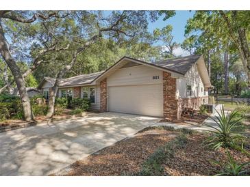 Charming single Gathering house with a two-car garage surrounded by mature trees at 921 Torchwood Dr, Deland, FL 32724